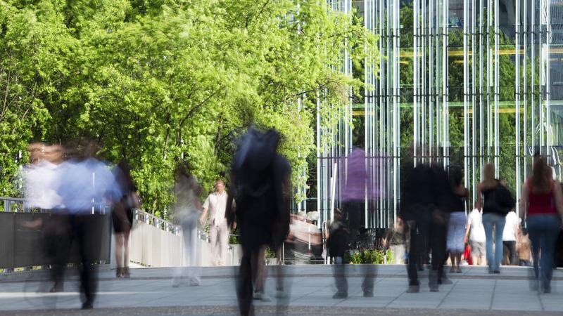 People walking outside of an office building.