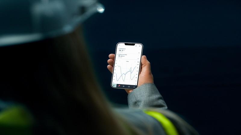 Woman looking at measurement graphs on her mobile phone