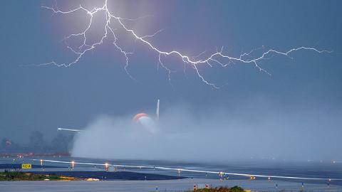 Plane taking off in lightning