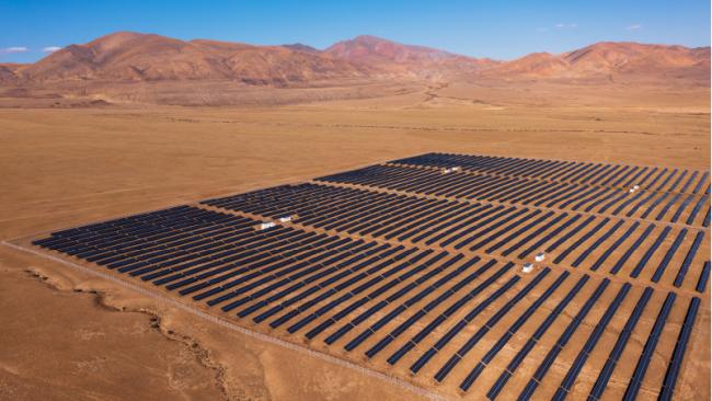 Panoramic aerial view of a large solar farm in the desert