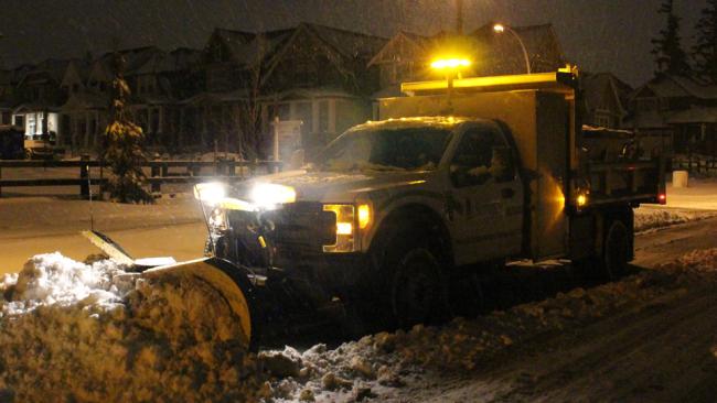 Snow plow working at night